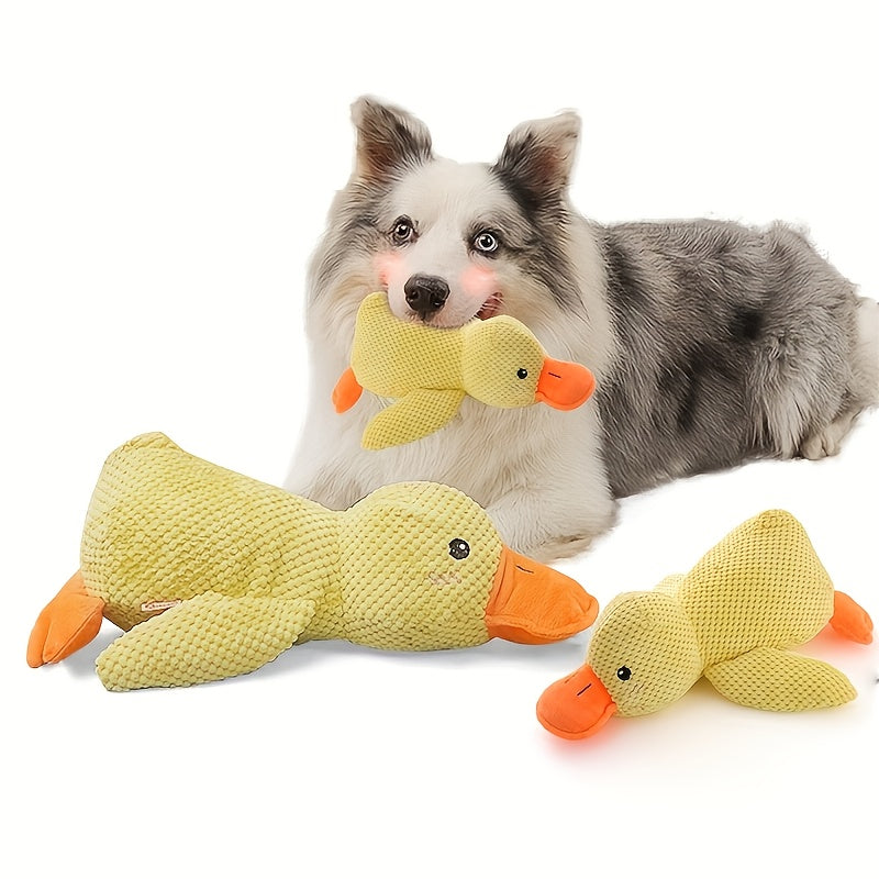 Dog playing with plush duck toy indoors