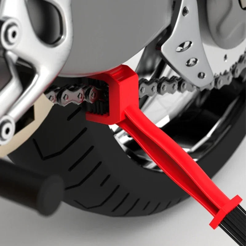 Motorcycle chain brush cleaning chain links during routine maintenance